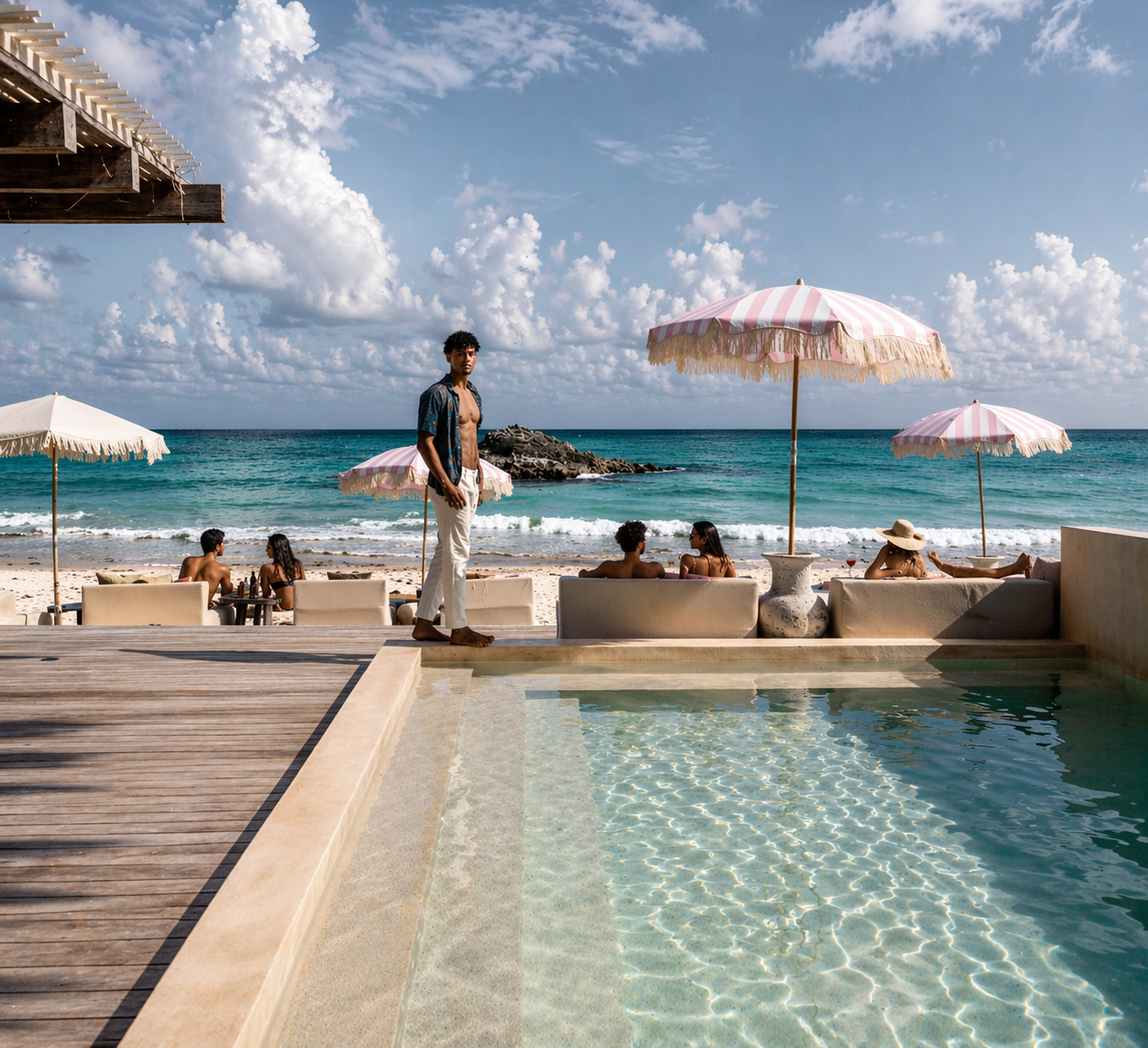 Chi Ka Chica beach club pool with pink umbrellas and Caribbean view