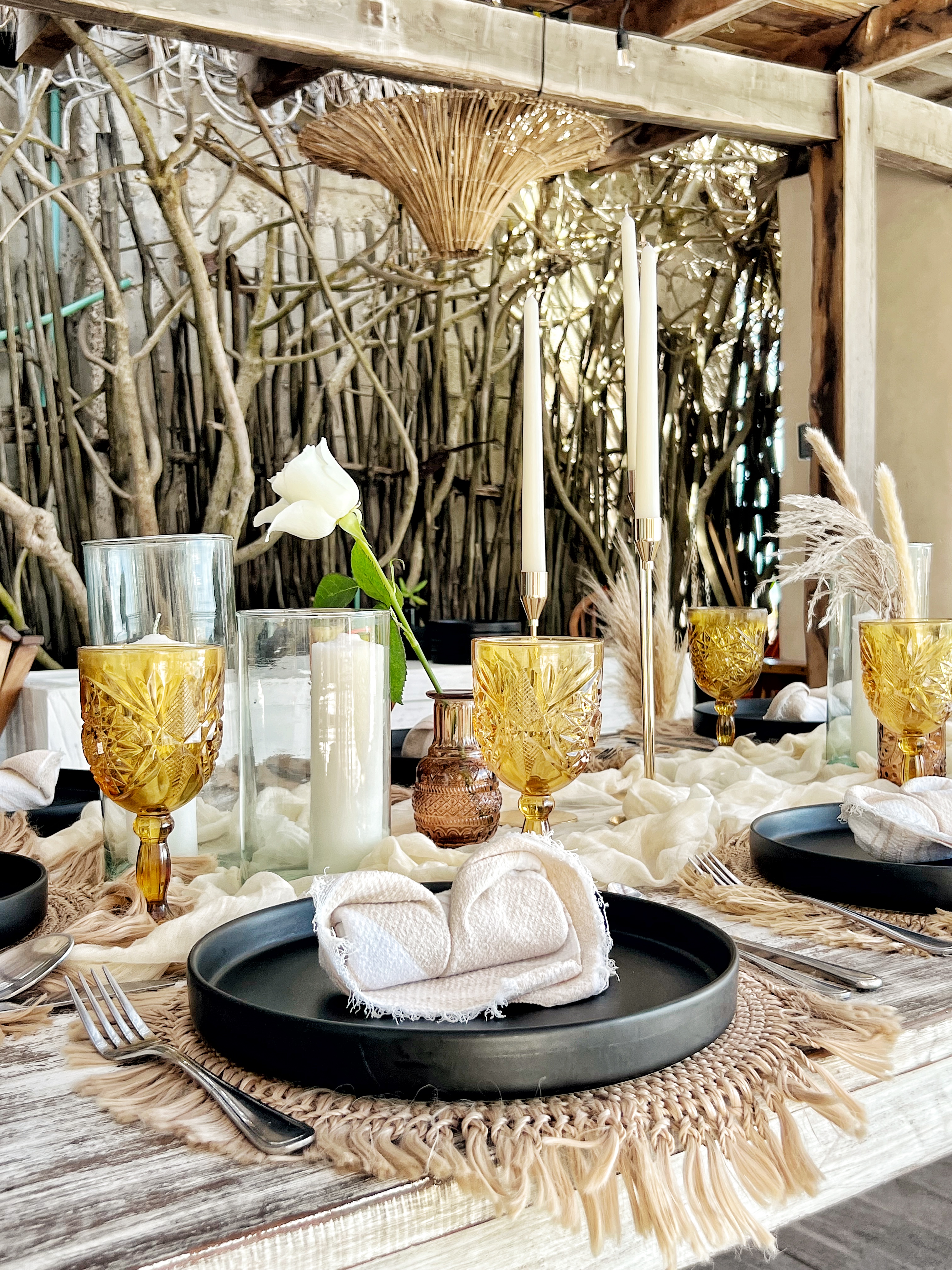 Boho table setting with amber glasses at Chi Ka